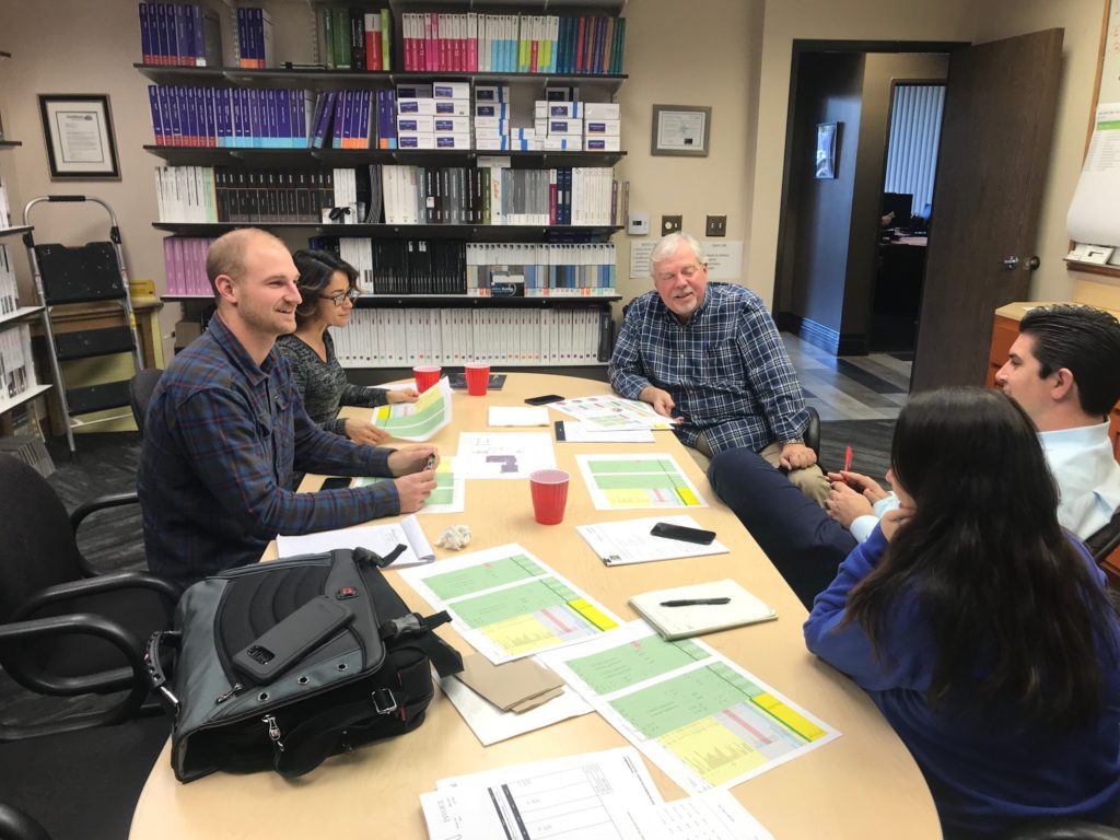 People sitting around a conference table discussing a flooring project