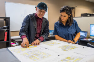 Man and woman reviewing bluprints