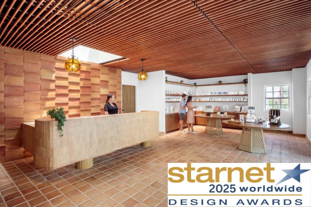 Reception area at Murietta Hot Springs: brown tile floor wood slatted ceiling -woman standing behind respetion desk
