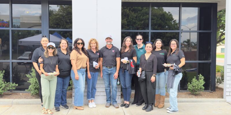 Learning, Laughing &Amp; Leveling Up: Universal Metro At Big D’s Customer Appreciation Event 2 Group of people posing together outdoors.